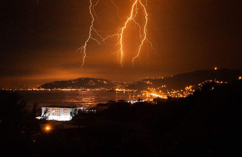 Lightning storm over a coastal town — 24/7 emergency and storm electrical repair in New Smyrna Beach